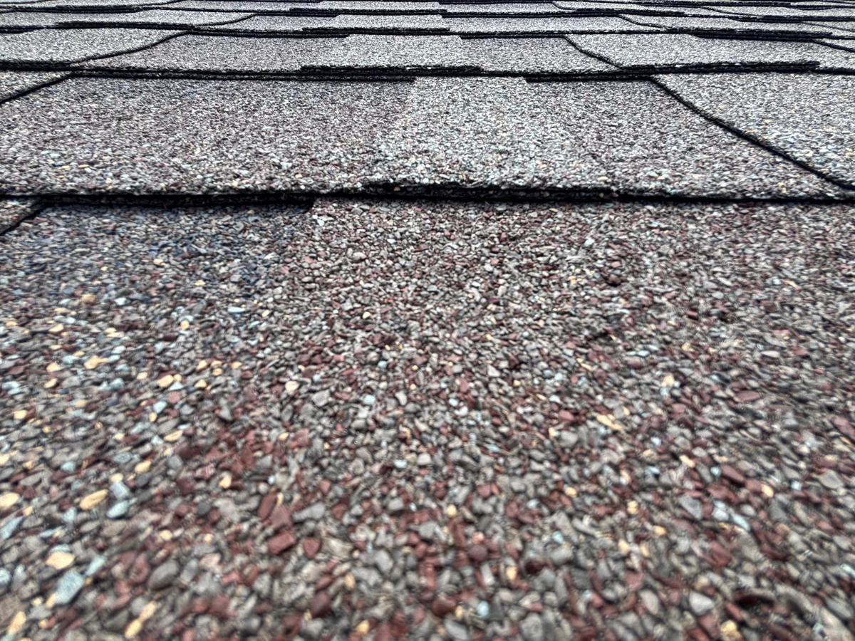 Close view of asphalt shingle texture and overlapping courses